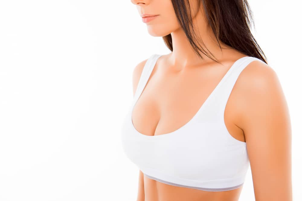 Woman in her late 30s has elevated breasts after breast lift surgery in Naples, FL.